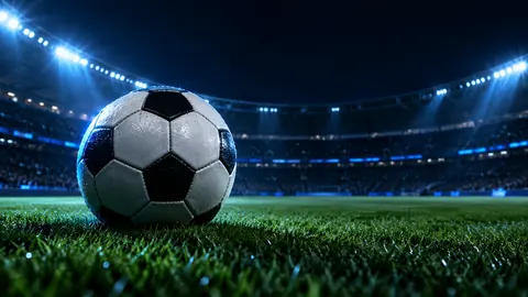 Bola de futebol em estádio noturno